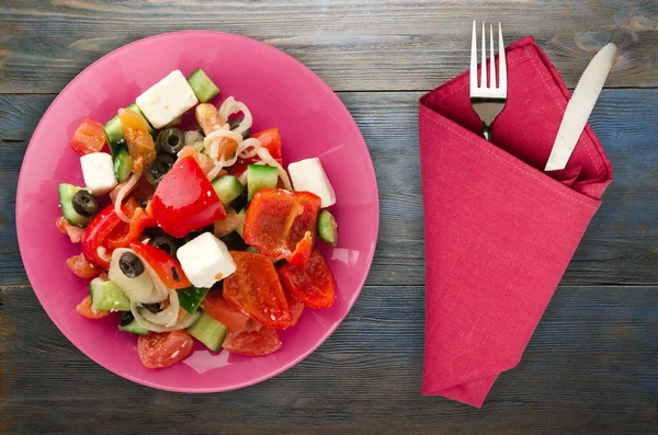 Greek salad on a wooden background — Stock Photo, Image