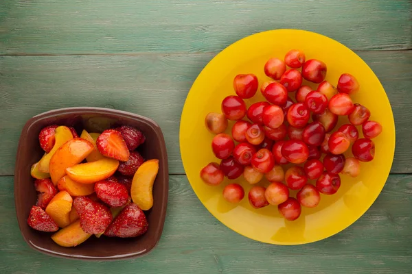 sweet cherry on a plate. sweet cherry on a wooden background. he