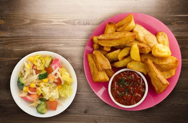 Batatas fritas em um fundo de madeira — Fotografia de Stock