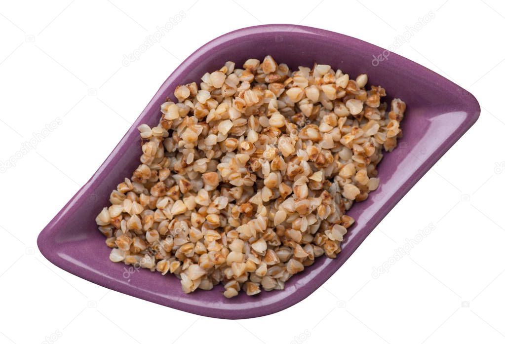 buckwheat in a plate isolated on white background. buckwheat top