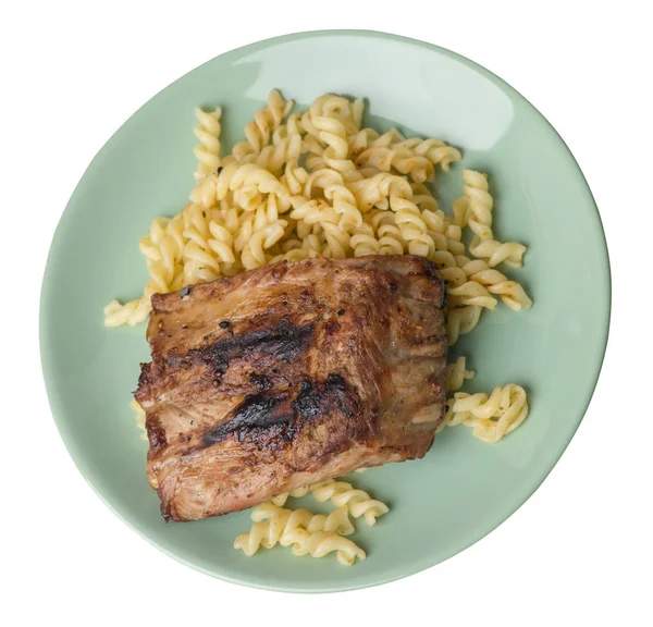 grilled pork ribs with pasta. grilled pork ribs on a  plate isol