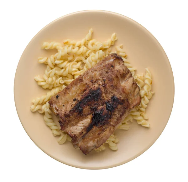 grilled pork ribs with pasta. grilled pork ribs on a  plate isolated on white background top view