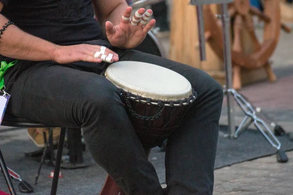 ethnic percussion musical instrument jembe and male hands