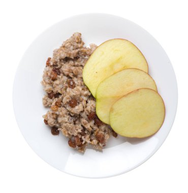 kuru üzüm ve elma ile çavdar gevreği bir tabakta. pullar izole