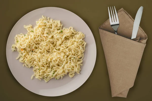 Vermicelli auf einem hellgrauen Teller. Vermicelli auf braunem Rücken — Stockfoto