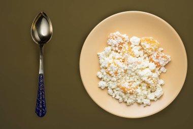  bej bir tabakta şeftalili süzme peynir, kahverengi yeşil