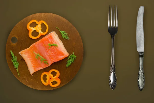 red fish trout fillets on a brown wooden  plate. fish trout on a