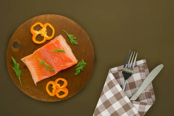 Red fish trout fillets on a brown wooden  plate. fish trout on a — Stock Photo, Image