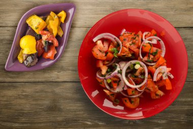 Vejetaryen yemeği. Domates, soğan, kırmızı tabakta rezene kahverengi ahşap arka planda. sağlıklı yiyecekler