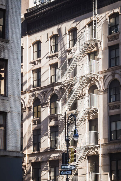 One way or another in the streets of New York between old buildings typic of the city and outdoor fire escapes