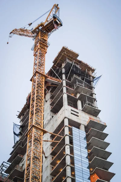 Skyscraper under construction with crane in the heart of Manhattan - Building under construction