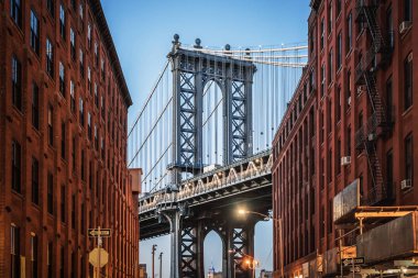 Dumbo - The famous Manhattan bridge between two red brick buildings in Brooklyn clipart