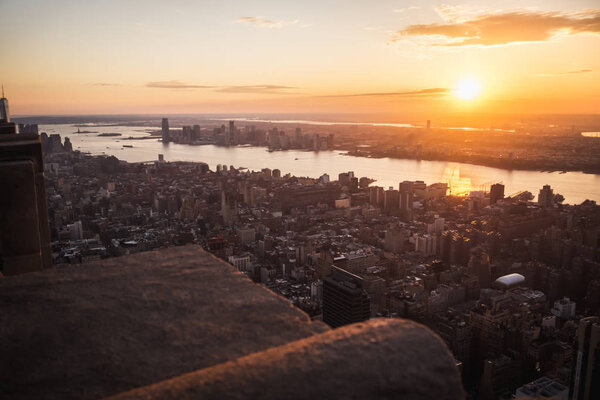 Aerial view of sun shining at sunset over Manhattan and Jersey in New York