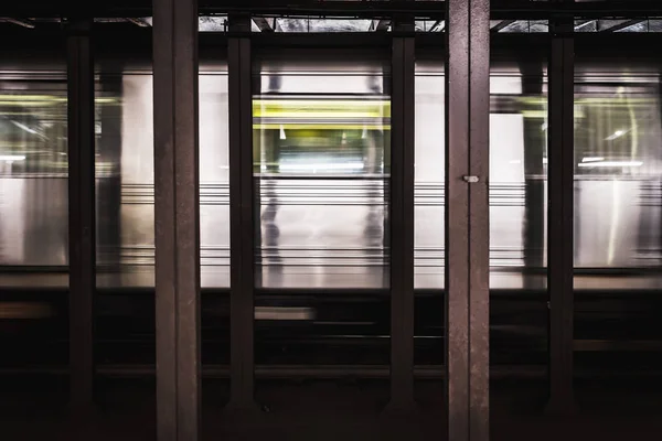 Underground landscape of New York metro architecture with moving train passing through galleries — Stock Photo, Image