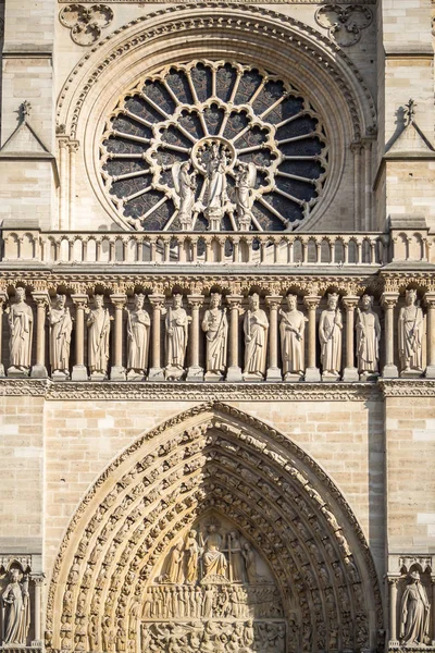 Rosette and statues in front of Notre Dame cathedral in Paris