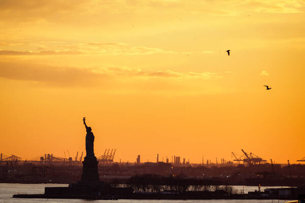 Yellow sunset on the statue of Liberty