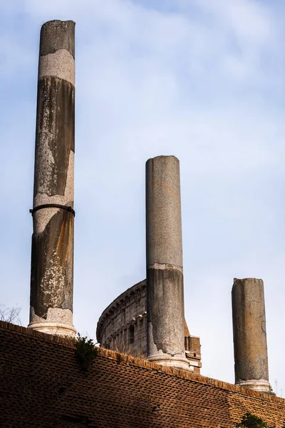 Ancient columns of the Sacred Way in front of the Colosseum in Rome, Italy