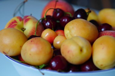 Taze meyveler ve meyveleri olan bir tabak. Tatlı kiraz, kayısı, şeftali ve nektarinler. Vitaminler ile sağlıklı gıda.      