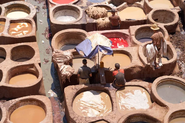 People work at a leather tanneries of Fez in Morocco.