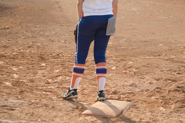 Player stand on home plate in a baseball (softball) dusty field, with copyspace