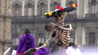 Mexico City, Kasım 2019. Mexico City 'de Ölüm Günü sırasında şapkalı ve çiçekli dev bir karton iskelet kukla gösteriliyor..