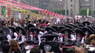 Mexico City, Kasım 2019. Kafatası ve mariachi kostümünden yapılmış bir grup genç Mexico City 'deki Ölüler Günü geçit töreninde davul çalıyor..