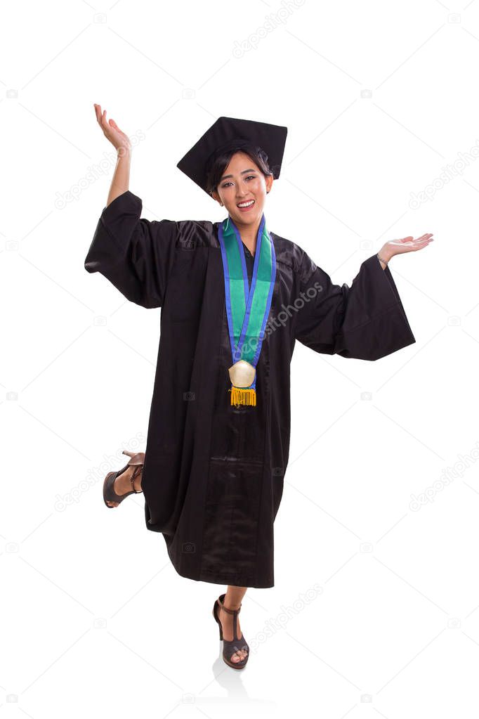 Attractive young Asian female student expressing her excitement of graduating. Dressed up in graduation cap and gown. Full body portrait over white background