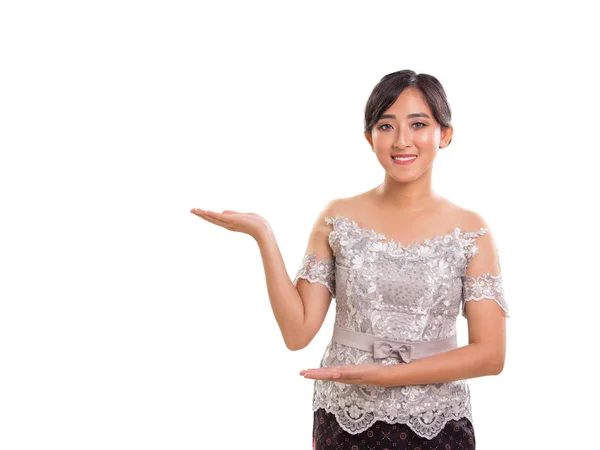 Lovely young Souteast Asian lady gesturing promotion or giving s — Stock Photo, Image