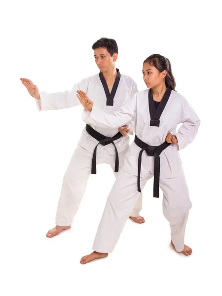 Male and female martial art practitioners perform strike move — Stock Photo, Image