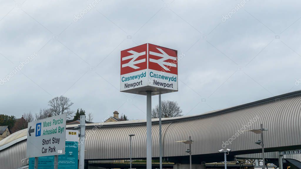 Newport, Wales - Feb 16, 2019: Newport British Rail sign, Casnewydd in Welsh Language, shallow depth of field horizontal photography