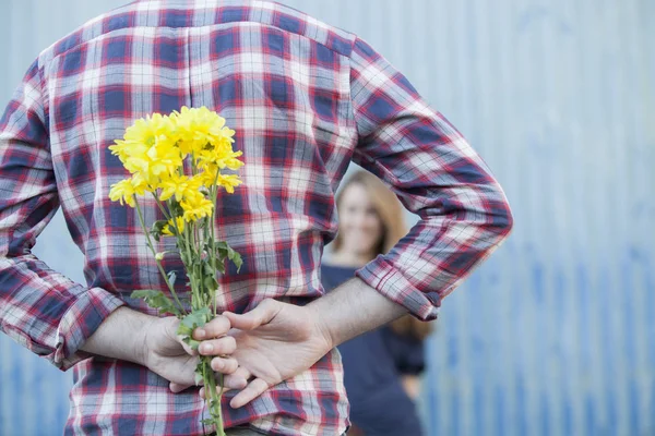 Man gives a bouquet of flowers to woman. Husband gives a gift to his wife. Valentines day concept