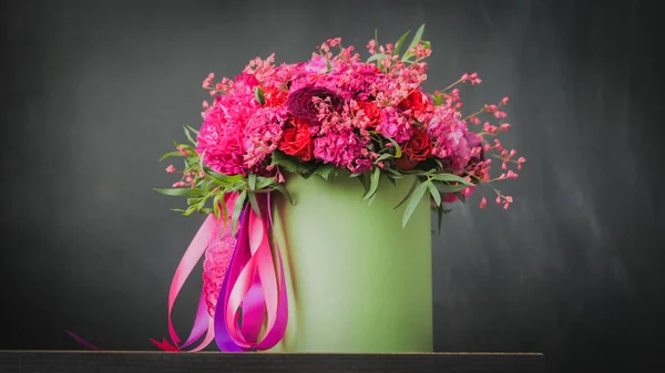 Beautiful wedding bouquet in green box on the black background