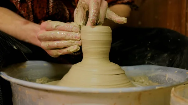 Professional male potter making ceramics in workshop