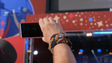 Akıllı telefonlu canlı müzik konserinin görüntülerini kaydeden eller.