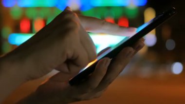 Şehirde akıllı telefon kullanan bir kadın.
