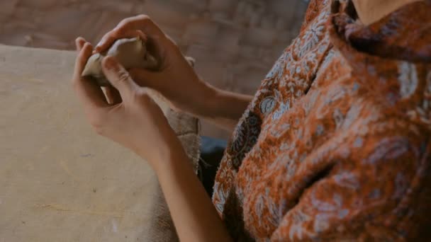 Woman potter making ceramic souvenir penny whistle in pottery workshop — Stock Video