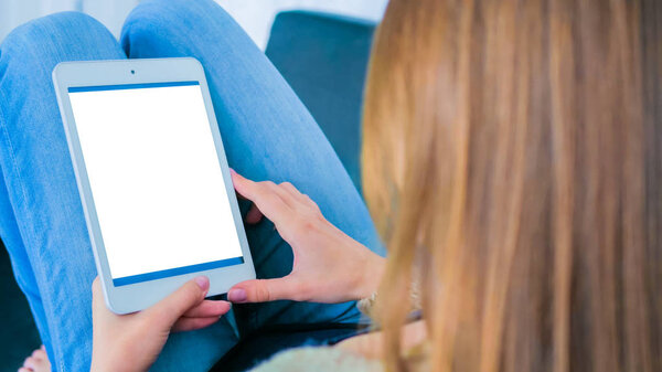 Woman using tablet computer with white empty display