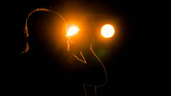 Photographer silhouette taking photos of concert at night — Stock Photo, Image