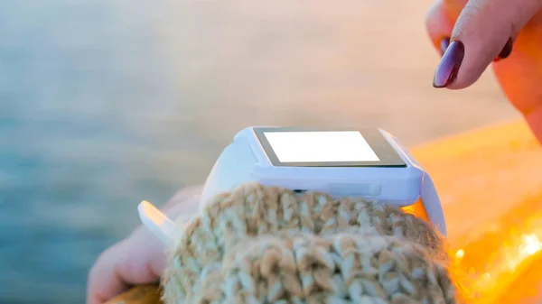 Woman using wearable smartwatch with empty white screen