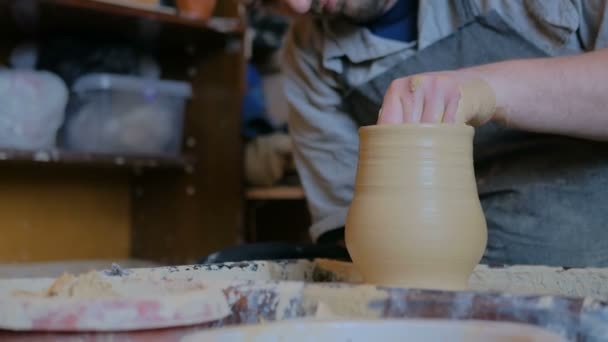 Professional potter shaping pot in pottery workshop — Stock Video