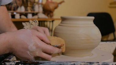 Çömlek atölyesinde özel bir aletle profesyonel çömlekçi şekillendirme kabı