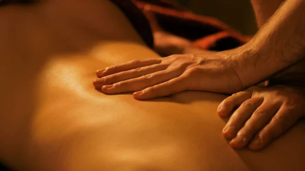 stock image Masseur hands doing back massage in spa center