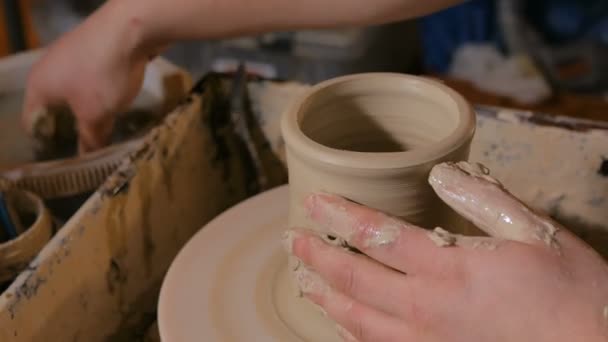 Professional potter shaping pot in pottery workshop — Stock Video