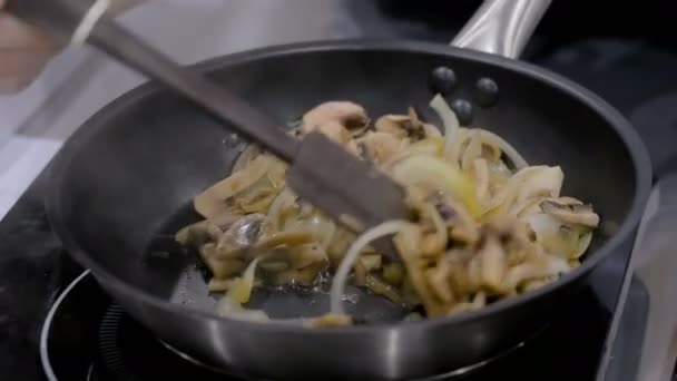 Μανιτάρια και κρεμμύδια που τηγανίζονται και ψήνομαι σε τηγάνι — Αρχείο Βίντεο