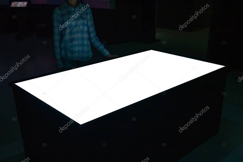 Mockup image - woman looking at white blank touchscreen display kiosk