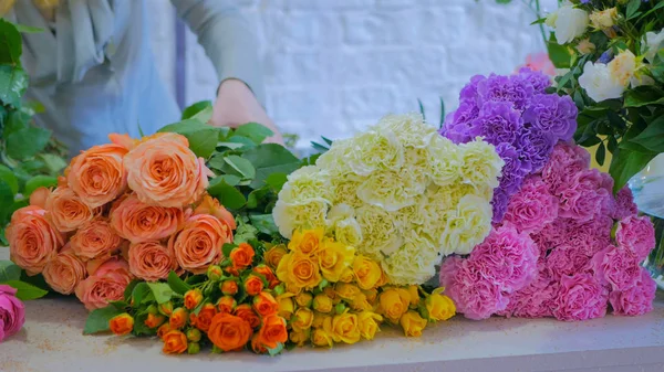 Professional floral artist sorting flowers at studio