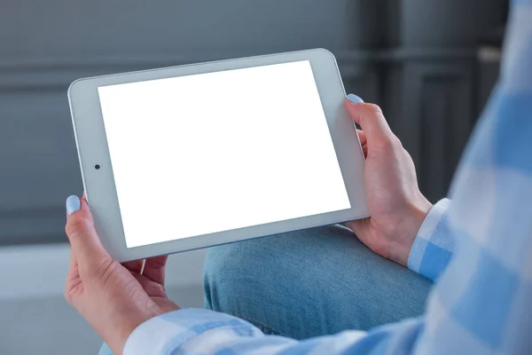 Woman holding digital tablet device with white blank screen - mockup image