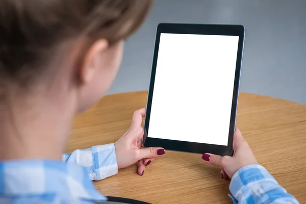Mockup image - woman looking at tablet computer with white empty display