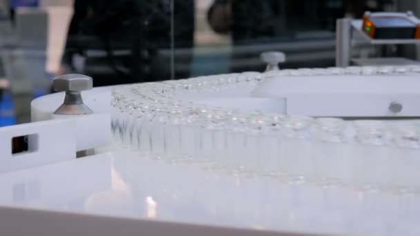 Pharmaceutical technology concept - conveyor belt with empty glass bottles — Stock Video