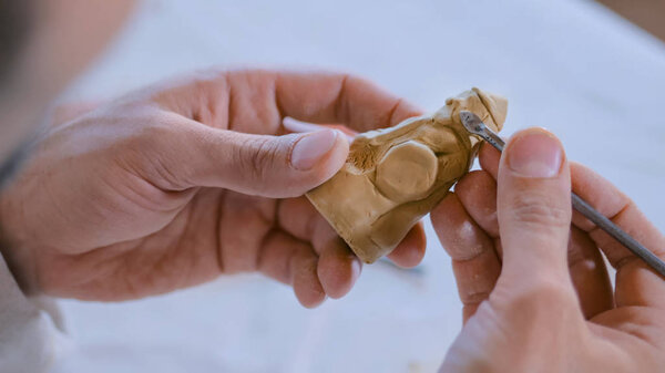 Potter making clay figure for board game